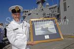 ID 6259 HMNZS OTAGO (P148) the first of two new OPV's (offshore patrol vessels) - Warrant Officer Michael O'Carroll, acting as Command Warrant Officer, with a painting of the frigate HMNZS Otago of 1960.